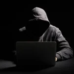 depositphotos_272424264-stock-photo-hacker-working-laptop-dark