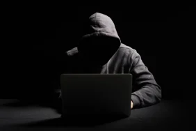 depositphotos_272424264-stock-photo-hacker-working-laptop-dark