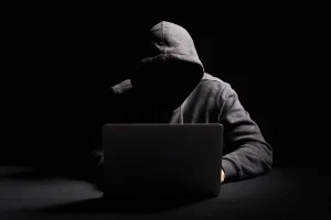 depositphotos_272424264-stock-photo-hacker-working-laptop-dark