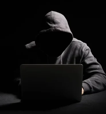 depositphotos_272424264-stock-photo-hacker-working-laptop-dark