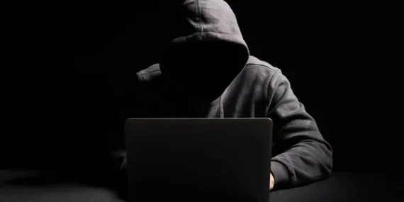 depositphotos_272424264-stock-photo-hacker-working-laptop-dark